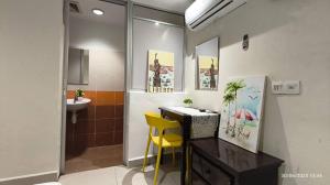 a bathroom with a desk and a yellow chair at KK Kajang in Kajang