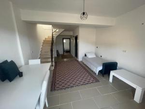 a bedroom with a bed and a staircase in a room at Duplex house with panoramic view in Gökçeada