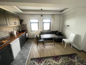 a kitchen and living room with a couch and a table at Duplex house with panoramic view in Gökçeada