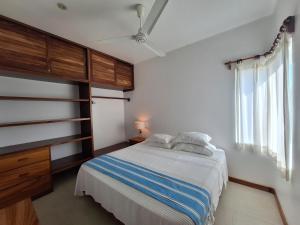 Schlafzimmer mit einem Bett, einer Kommode und Fenstern in der Unterkunft Tortugas dos cero uno in Puerto Escondido + 7 Fotos