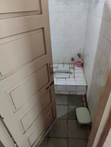 a small bathroom with two toilets and a door at hotel aadarsh in Sendhwa +63 photos