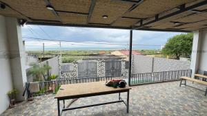 a balcony with a bench and a table on a patio at sunnyhome 2 wide spaces in Ấp Ðại Tài (2) +7 photos