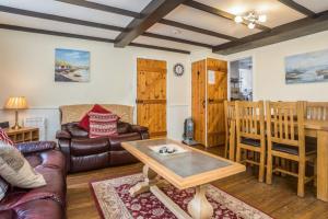 a living room with a couch and a table at Coble Cottage in Staithes