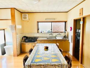 a kitchen with a table and a sink at 一棟貸しの宿 くらしHAUS Kurashi HAUS in Kuroshio +8 photos