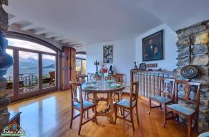 a dining room with a table and chairs at Villa i Tre Camini in Bellano