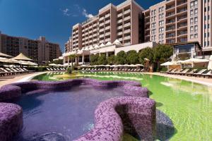 a swimming pool in the middle of a resort at SoloApartment in Sunny Beach