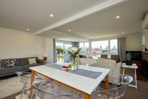 a living room with a table and chairs at Close To Beach, Sunny, Getaway - KK16786 in Kaikoura