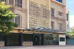 a building with awning on the side of it at Dancenter KR Hotel in Palembang