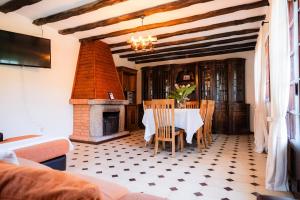 a dining room with a table and a fireplace at Casa Montanha in Campo do Gerês