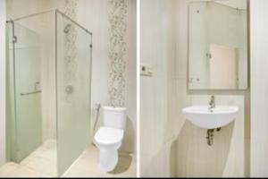 a bathroom with a toilet a sink and a shower at Dancenter KR Hotel in Palembang +25 photos
