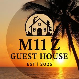 a guest house on the beach with a palm tree at M11 Z Guest House in Pasuquin