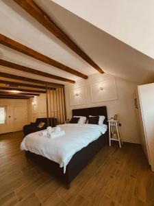 a bedroom with a large bed with white sheets at RajRaj apartmani Gradiska in Bosanska Gradiška +51 photos