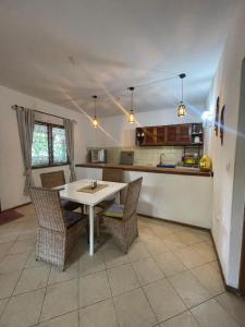 a kitchen with a table and chairs in a room at Marially Luxury Bed and Breakfast in Malindi
