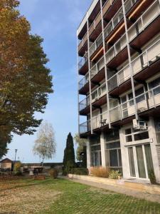 an apartment building with a lawn in front of it at Sunset by the lake in Siófok