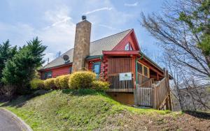 a red house with a chimney on a hill at Wanderlust in Sevierville