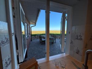 a view of a patio with a table and chairs at Kapitänshaus Meerblick in Langeneß