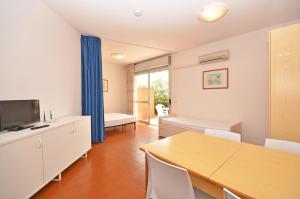 a living room with a table and a dining room at Residence Garuda in Cavallino-Treporti