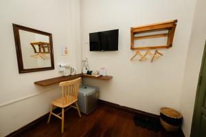 a room with a table and a mirror and a chair at Barn Laos Luangprabang Heritage in Luang Prabang +78 photos