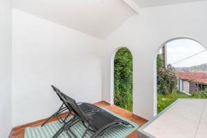a room with a chair and a table and a window at Maravillosa casa con jardín cerca de playa en centro de Asturias in Llodares +9 photos