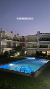 a swimming pool in front of a building at night at Vereniki 2 in Kriopigi
