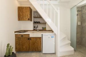 a kitchen with a sink and a staircase at Panda Blue&White Downtown in Megali Ammos +7 photos