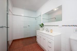 a white bathroom with a sink and a mirror at Cosy Coastal Beach Cottage in Rye in Rye +31 photos