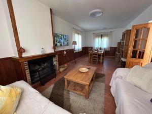 a living room with a couch and a coffee table at Casa rural Juan Pablo in Segura de la Sierra