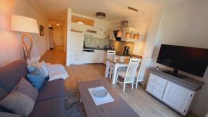 a living room with a couch and a table at Huk's 5 - Aurora Vista - ABC580 - nur Feriengäste! in Hohen Wieschendorf +30 photos