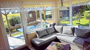 a living room with a couch and a large window at Ferienwohnung 3 - Zur Schwedenschanze - ABC563 - Nur Ferieng in Hohen Wieschendorf