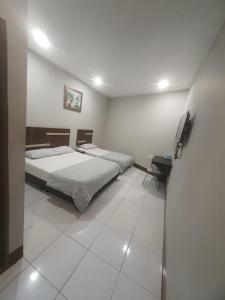 Postel nebo postele na pokoji v ubytování Ap Classic Hotel