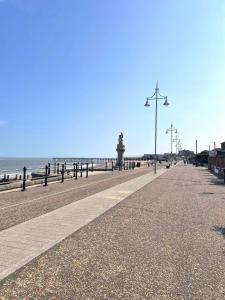 an empty street next to the ocean with a pier at Lowestoft One Bed Apartment, Close to Beach -Ideal for Weekend Getaways and Business Travellers- with Free Parking! in Lowestoft
