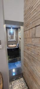 a bathroom with a tub and a stone wall at La Maison d'art de Hanoi in Hanoi