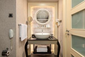 a bathroom with a sink and a mirror at Limak Eurasia Luxury Hotel in Istanbul