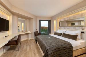 a hotel room with a bed and a desk and a computer at Limak Eurasia Luxury Hotel in Istanbul