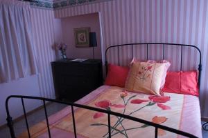 a bedroom with a bed with a black frame and red pillows at Camere In Centro in Agropoli