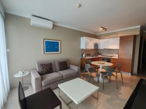 a living room with a couch and a table at Sunset Apartments in Podstrana