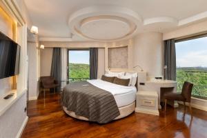 a hotel room with a bed and a large window at Limak Eurasia Luxury Hotel in Istanbul