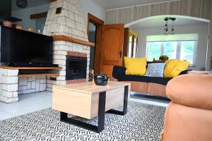 a living room with a couch and a fireplace at L Orchidée in Dinant