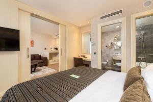 a hotel room with a bed and a bathroom at Limak Eurasia Luxury Hotel in Istanbul