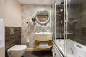 a bathroom with a toilet and a sink and a shower at Limak Eurasia Luxury Hotel in Istanbul
