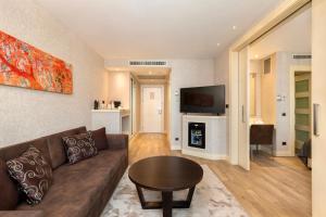 a living room with a couch and a table at Limak Eurasia Luxury Hotel in Istanbul
