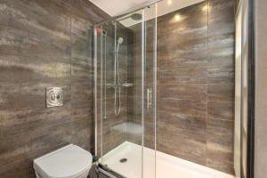 a bathroom with a shower and a toilet at Limak Eurasia Luxury Hotel in Istanbul