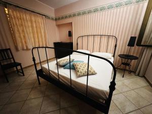 a bedroom with a bed with white sheets and pillows at Camere In Centro in Agropoli