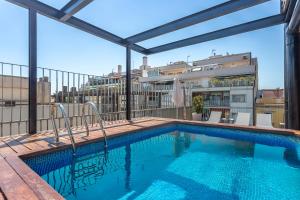 a swimming pool on the roof of a building at My Space Emirates - Fully equipped apartments near the Beach with shared pool in Barcelona