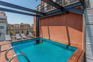 a swimming pool on the roof of a building at My Space Emirates - Fully equipped apartments near the Beach with shared pool in Barcelona