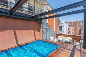 a swimming pool on the balcony of a building at My Space Emirates - Fully equipped apartments near the Beach with shared pool in Barcelona