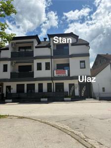 a building with a sign on the side of it at Apartment M&S in Bosanski Novi