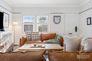 a living room with a couch and a table at Journeyman's Cottage in Ballarat