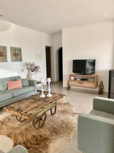 a living room with a couch and a coffee table at Beautiful Ibiza Style Villa Moraira in Teulada