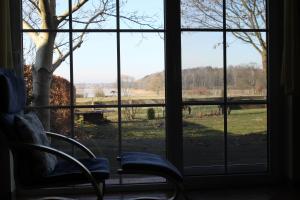 a room with a window looking out at a field at Ferienhaus Am See In Blankensee Groß Schönfeld in Blankensee